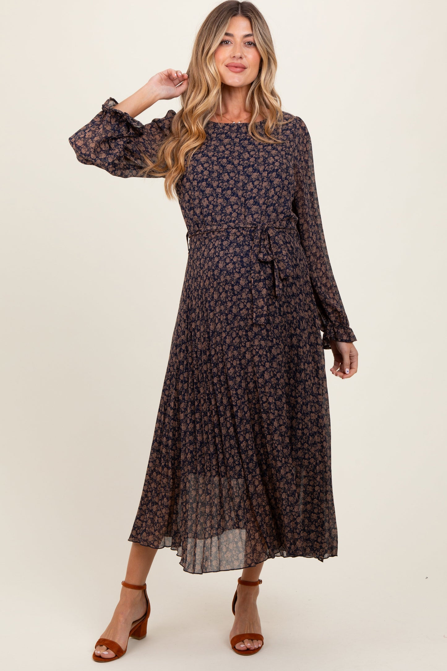 Woman wearing a dark floral dress on a white background