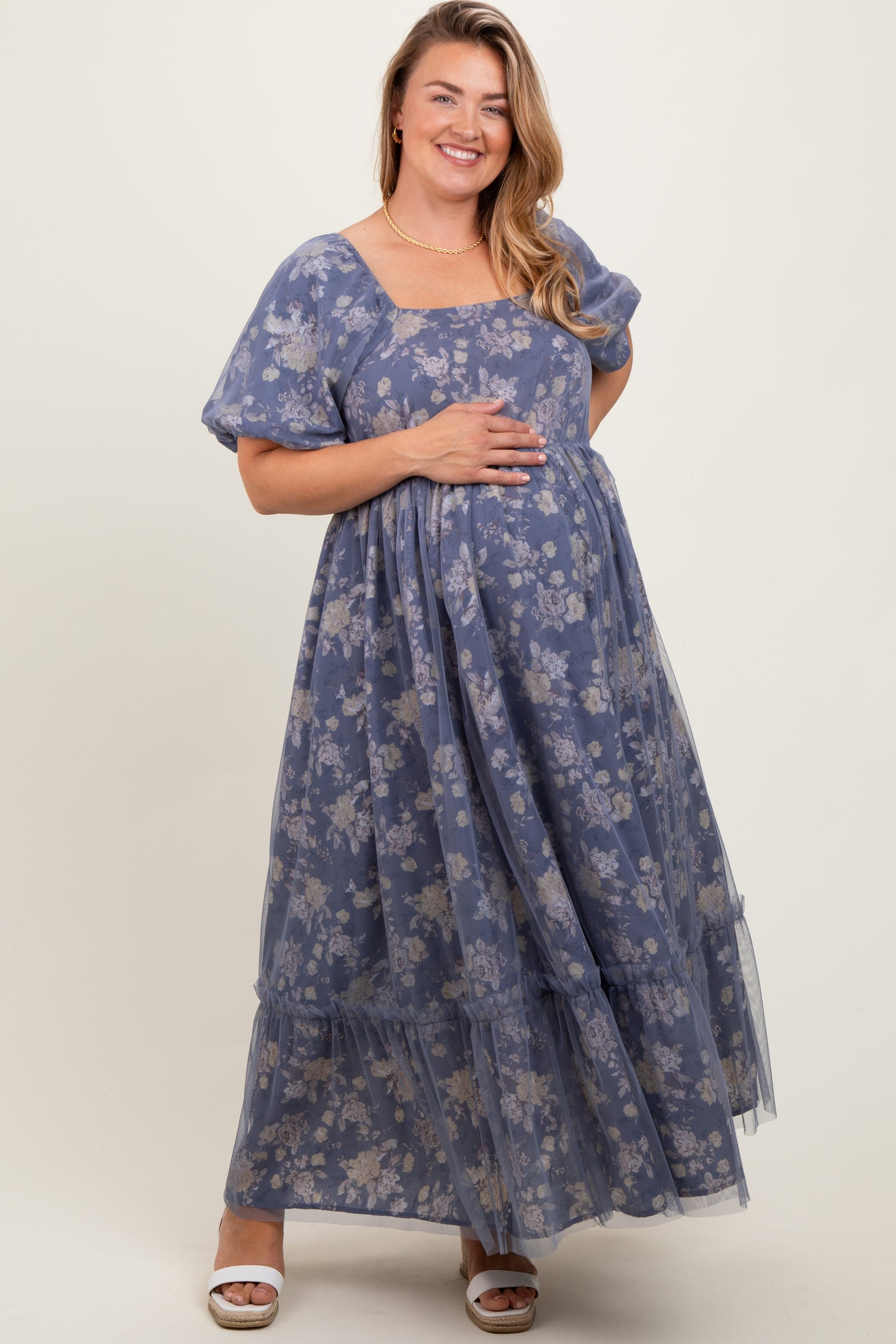 Woman wearing a blue floral dress on a white background