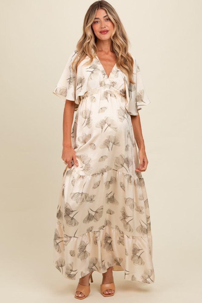 Woman wearing a floral dress against a plain background