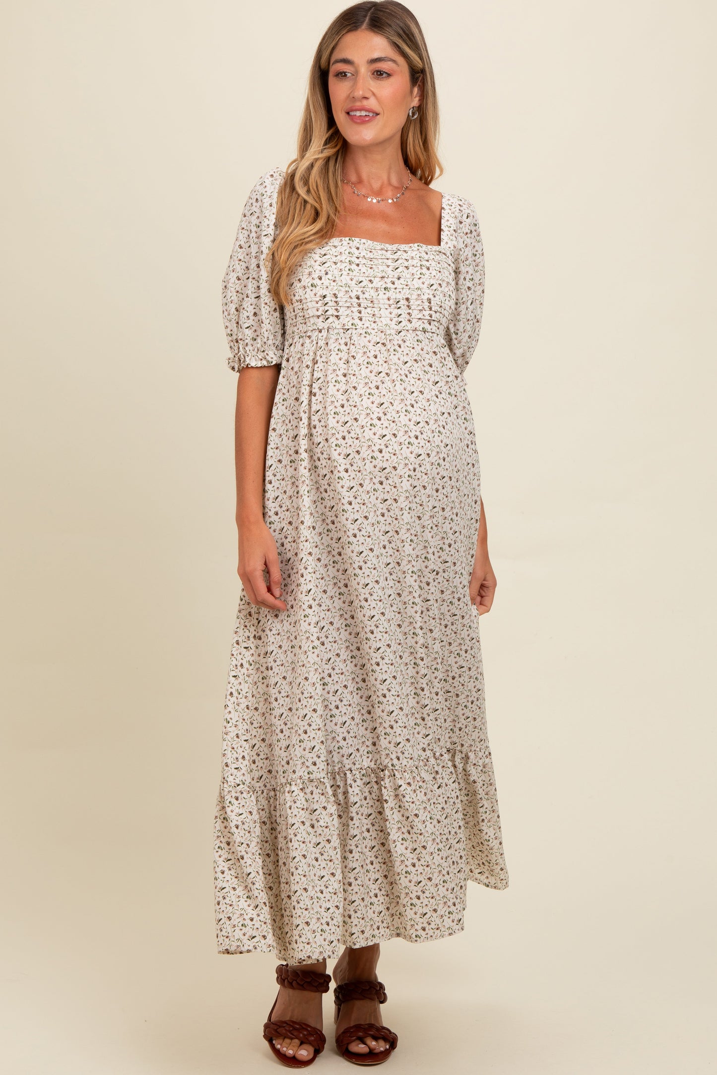 Woman wearing a floral dress against a beige background