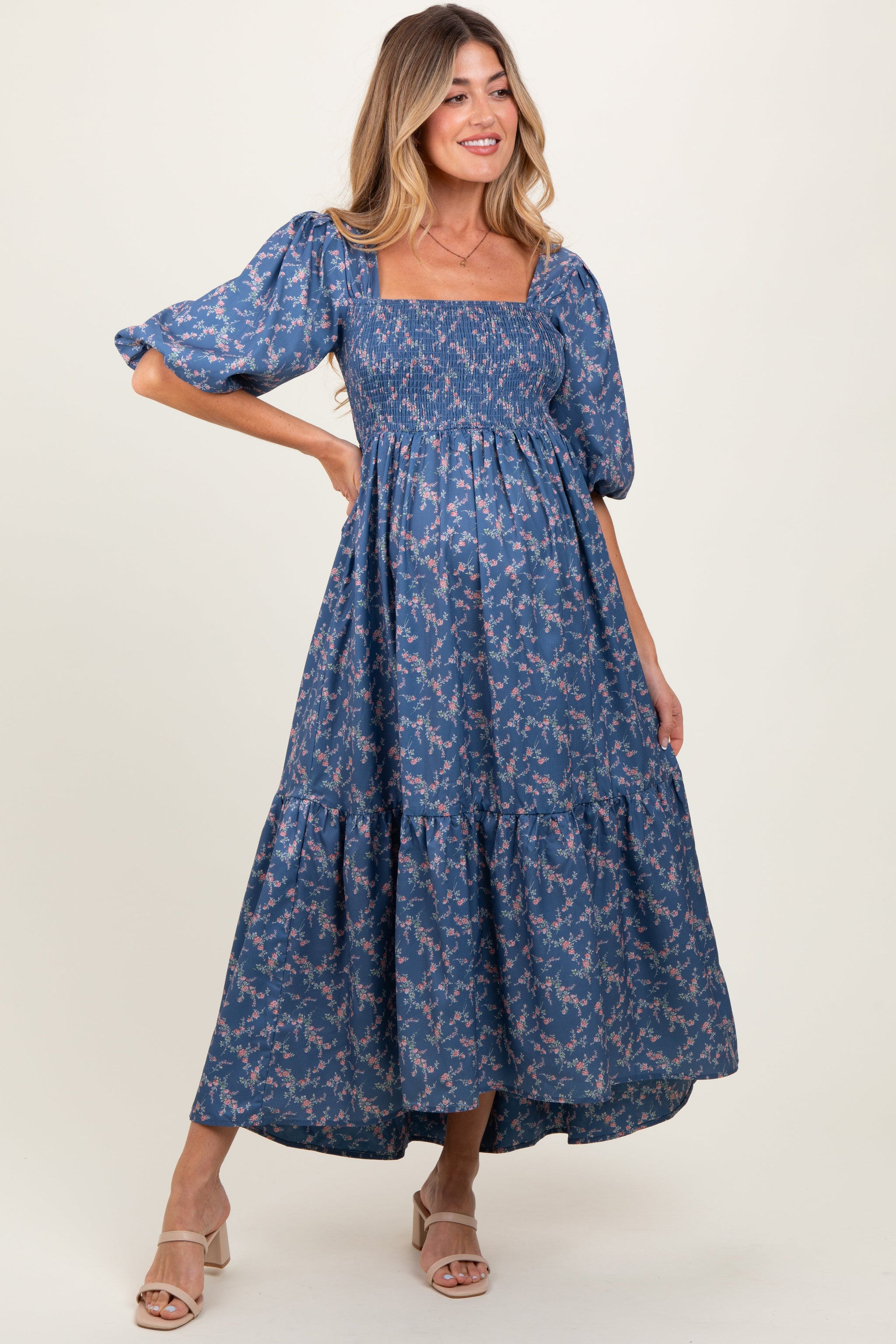 Woman wearing a blue floral dress on a white background