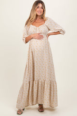 Pregnant woman wearing a beige floral dress on a white background
