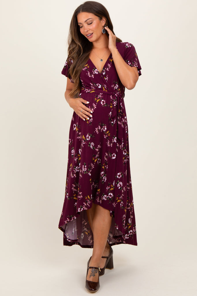 Woman wearing a purple floral dress on a white background