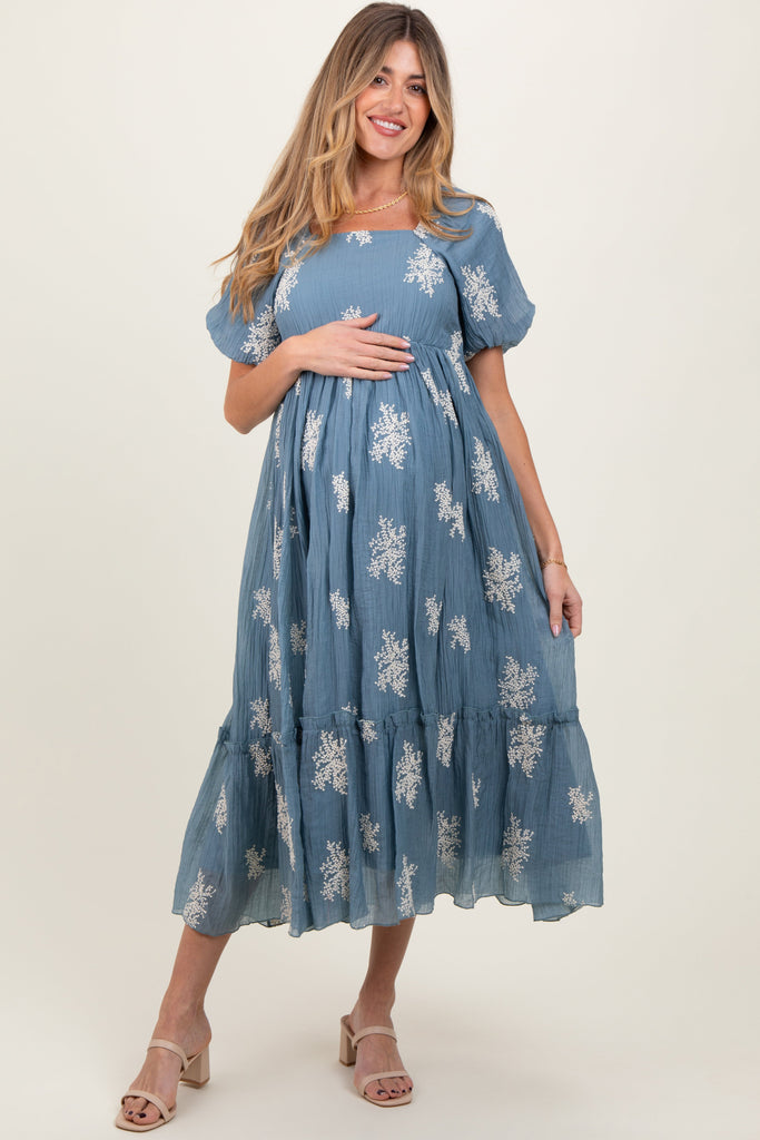 Woman wearing a blue floral dress on a white background