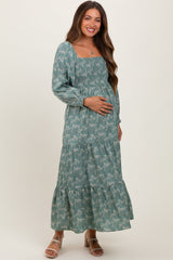 Woman wearing a green floral dress on a white background