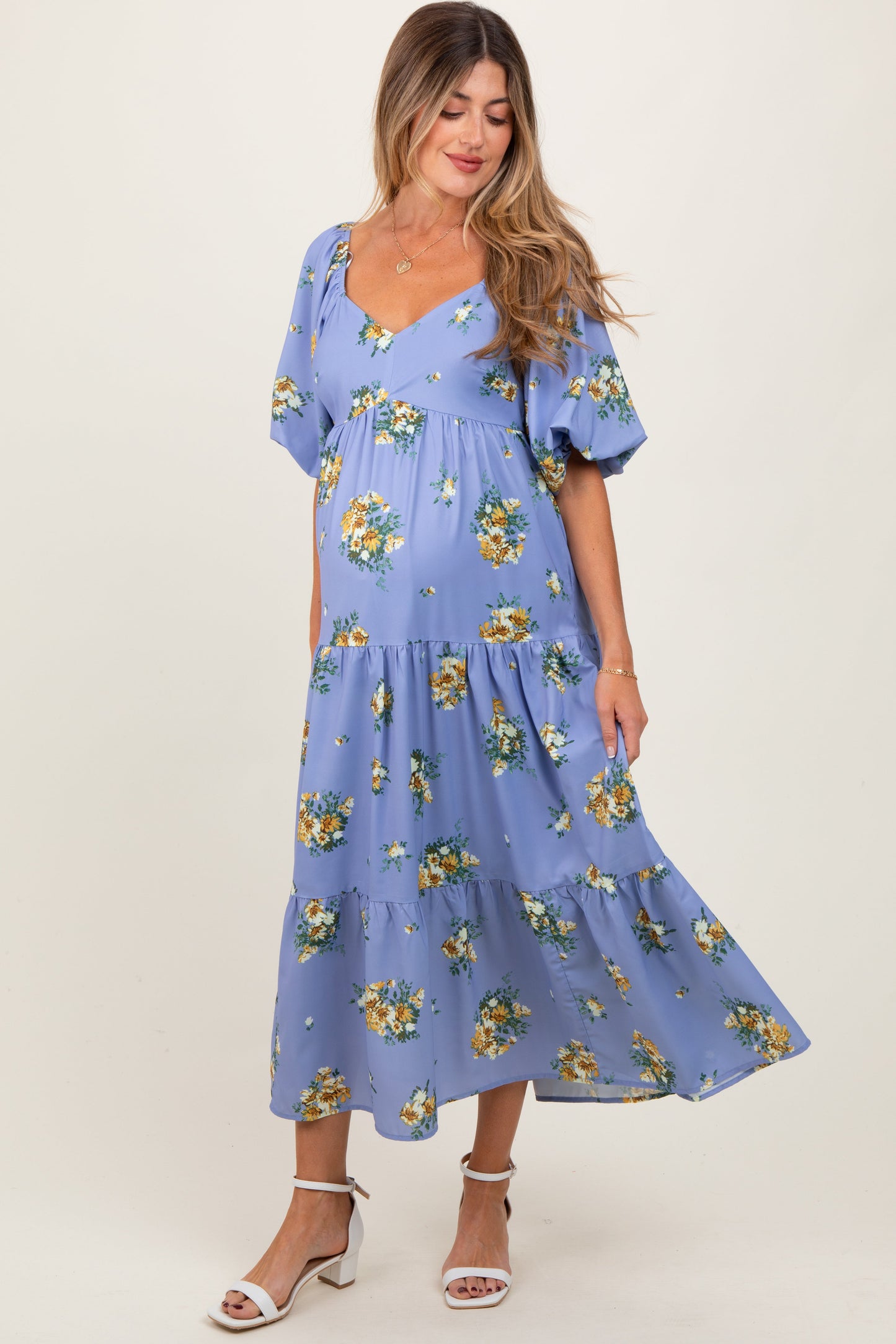 Woman wearing a blue floral dress on a white background
