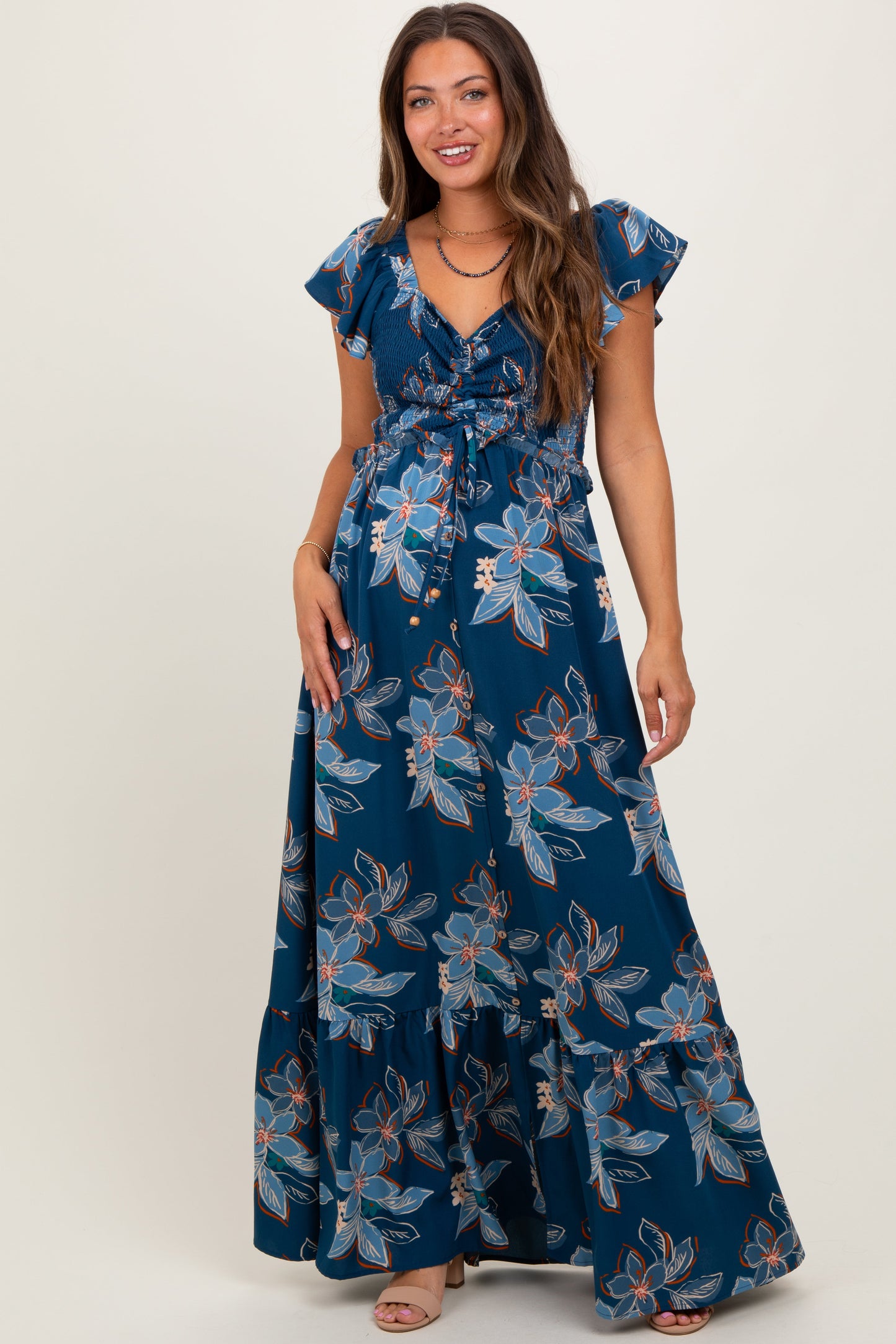 Woman wearing a blue floral dress on a white background