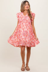 Woman wearing a pink floral dress on a white background