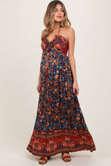 Woman wearing a floral maxi dress on a white background