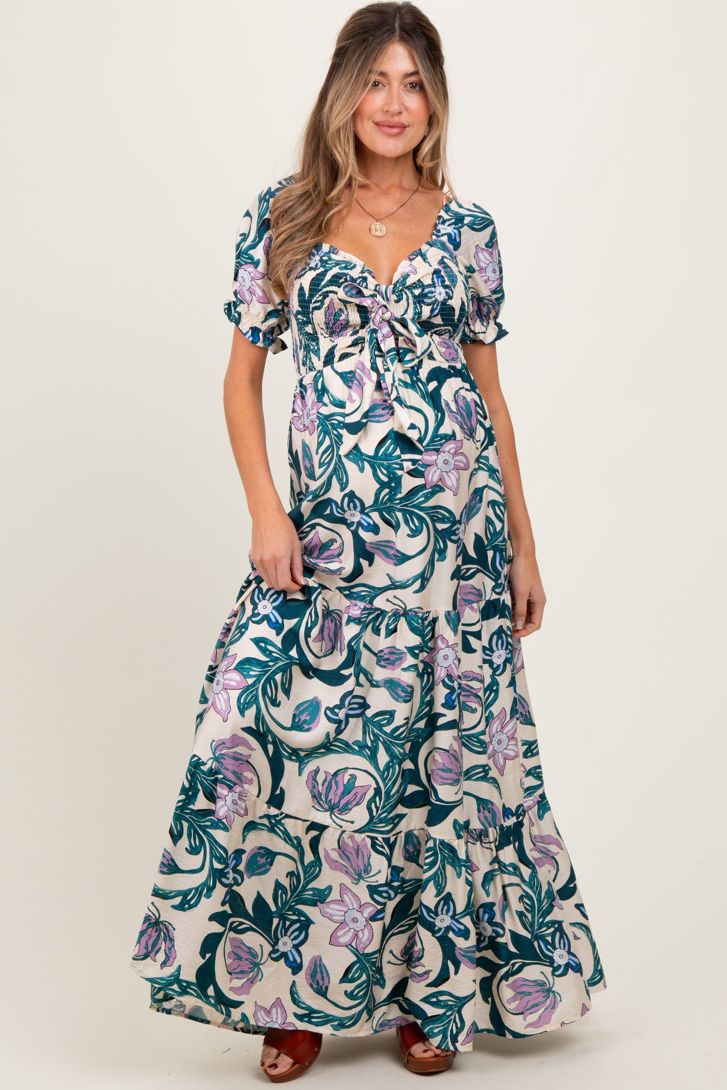 Woman wearing a floral dress on a plain background