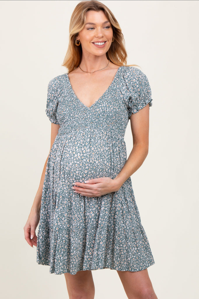 Woman wearing a floral dress on a plain background