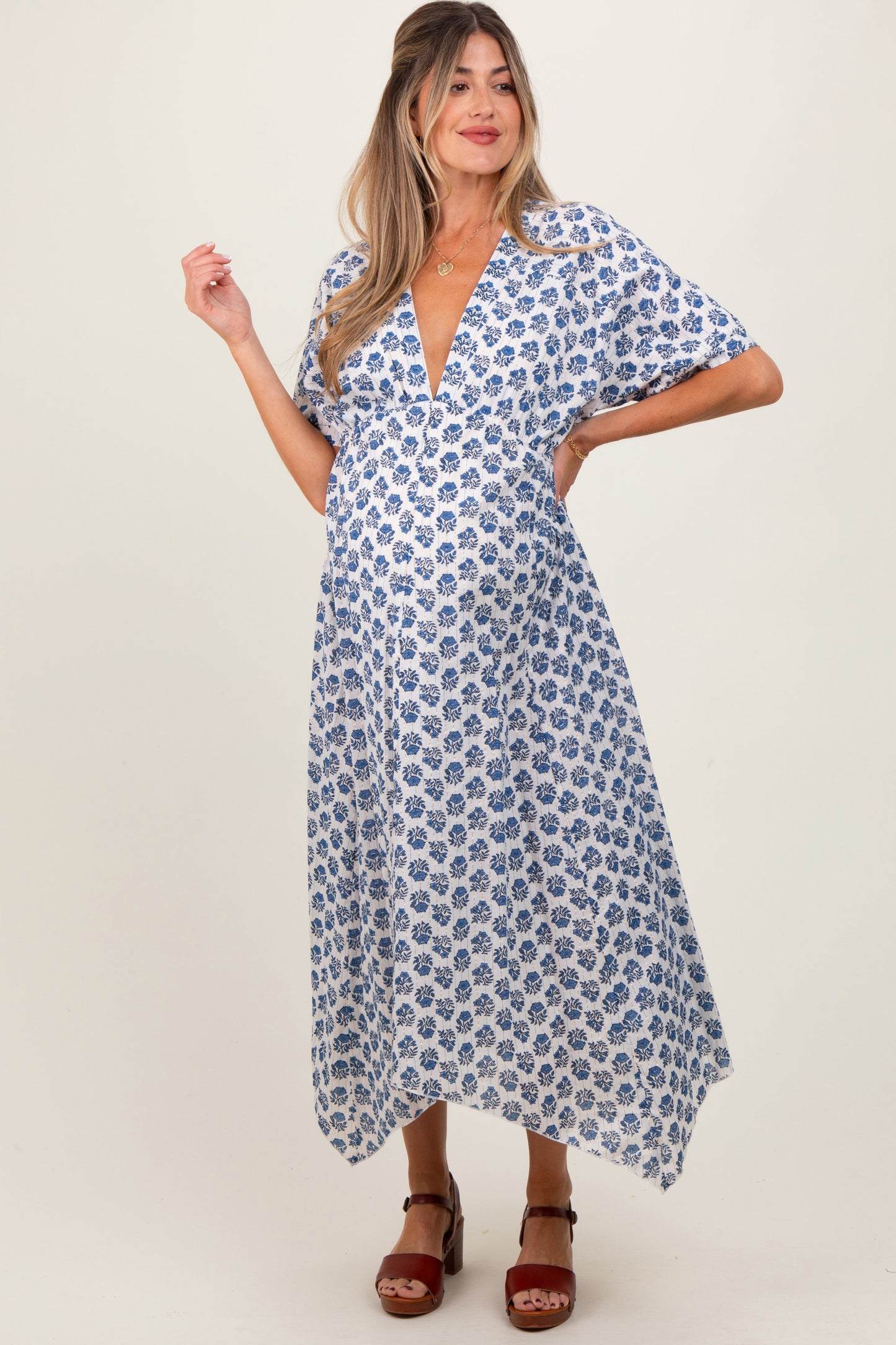 Woman wearing a blue floral dress on a white background