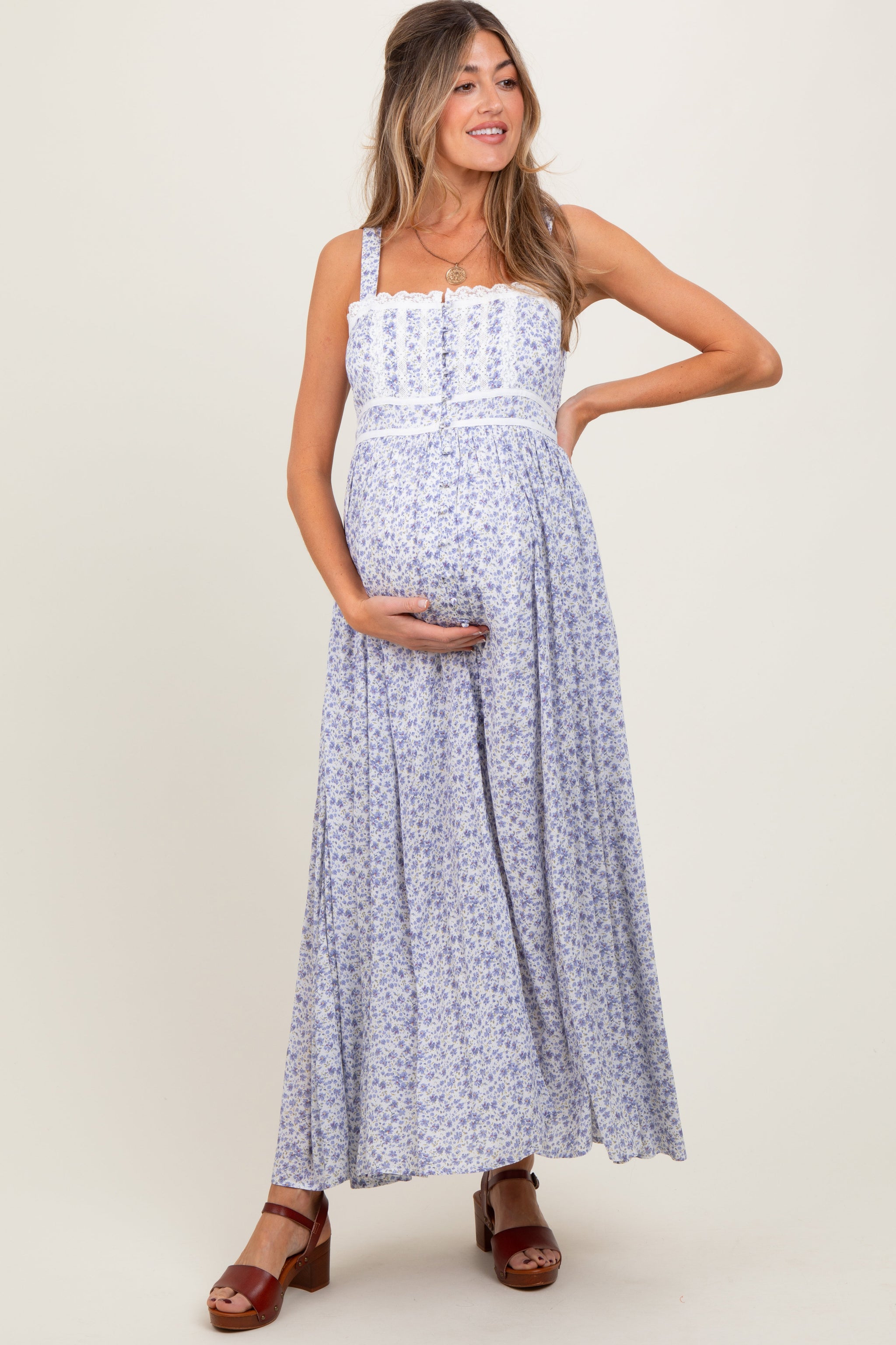 Woman wearing a blue floral dress on a white background