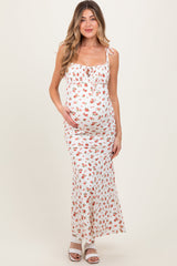 Woman wearing a white floral dress on a plain background