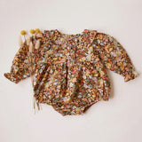 Floral-patterned baby romper on a light background