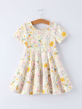 Floral dress on a hanger against a light gray background