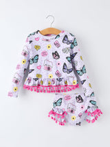 Children's outfit with butterfly and camera pattern on a white background