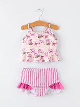 Children's two-piece swimsuit with pink and white pattern on a hanger against a white background