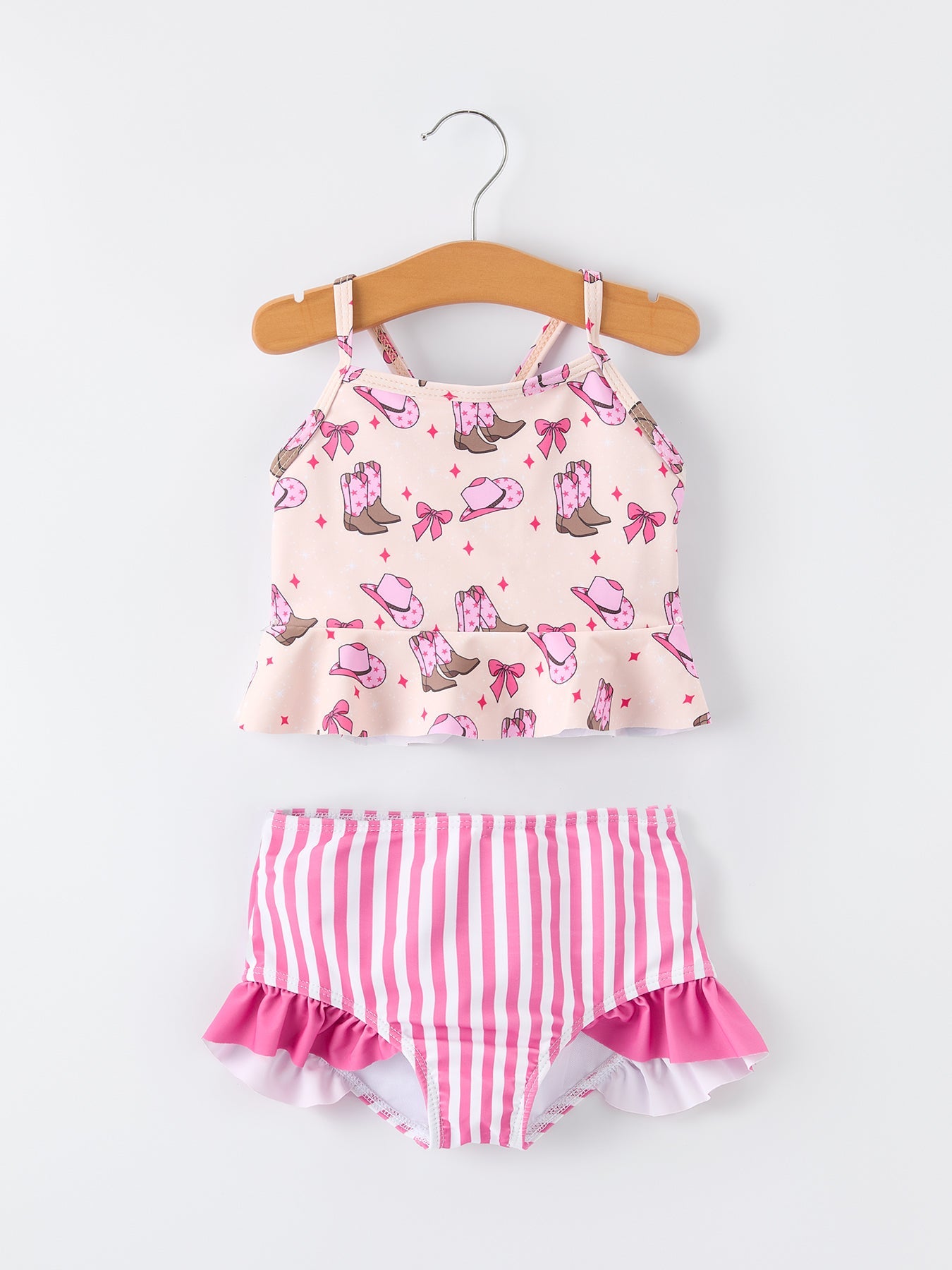 Children's two-piece swimsuit with pink and white pattern on a hanger against a white background