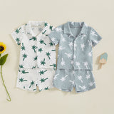 Children's pajama set with palm tree patterns on a beige background
