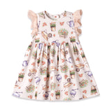 Children's dress with gardening-themed print on a white background