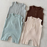 Four baby rompers in gray, green, brown, and beige on a neutral background