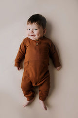 Ribbed long-sleeve onesie with two buttons and leg snaps, crafted from the softest organic cotton blend.