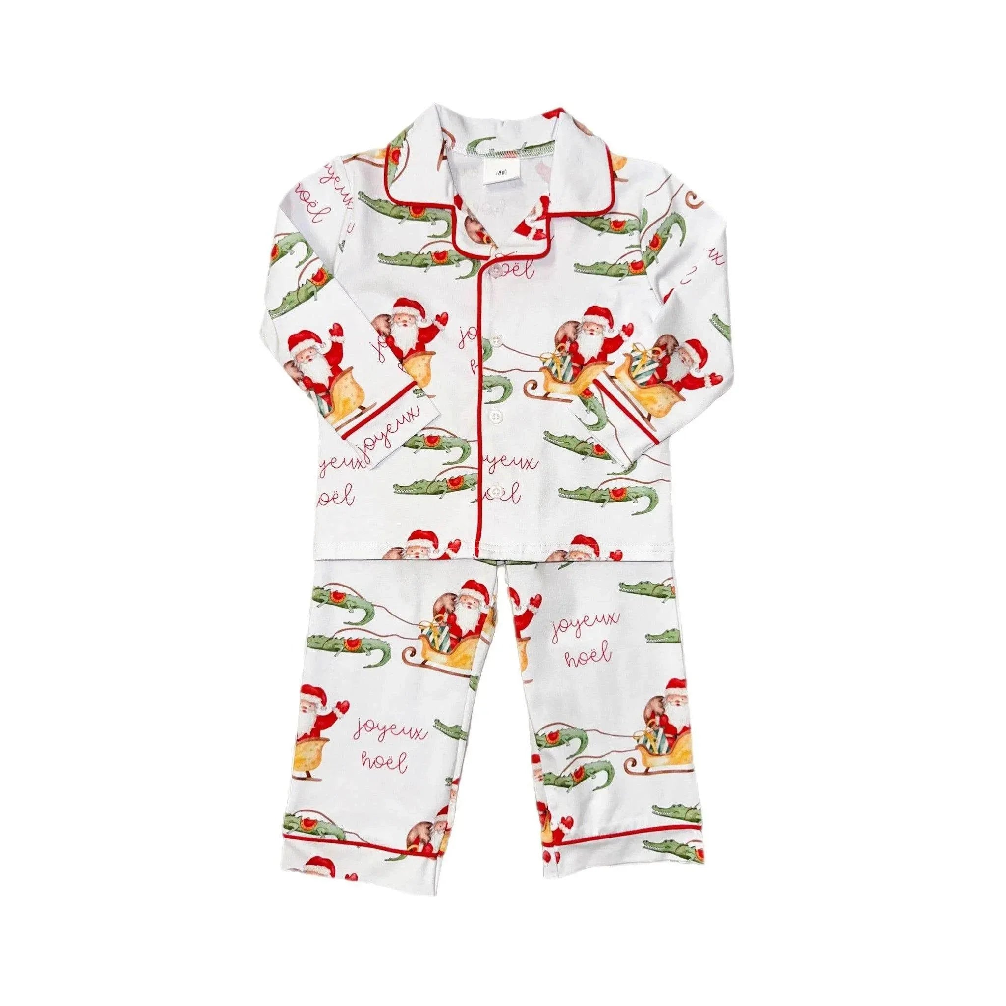 Christmas-themed pajama set with Santa Claus and candy cane design on a white background