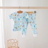 Baby outfit with short-sleeve shirt and pants on a hanger against a white background