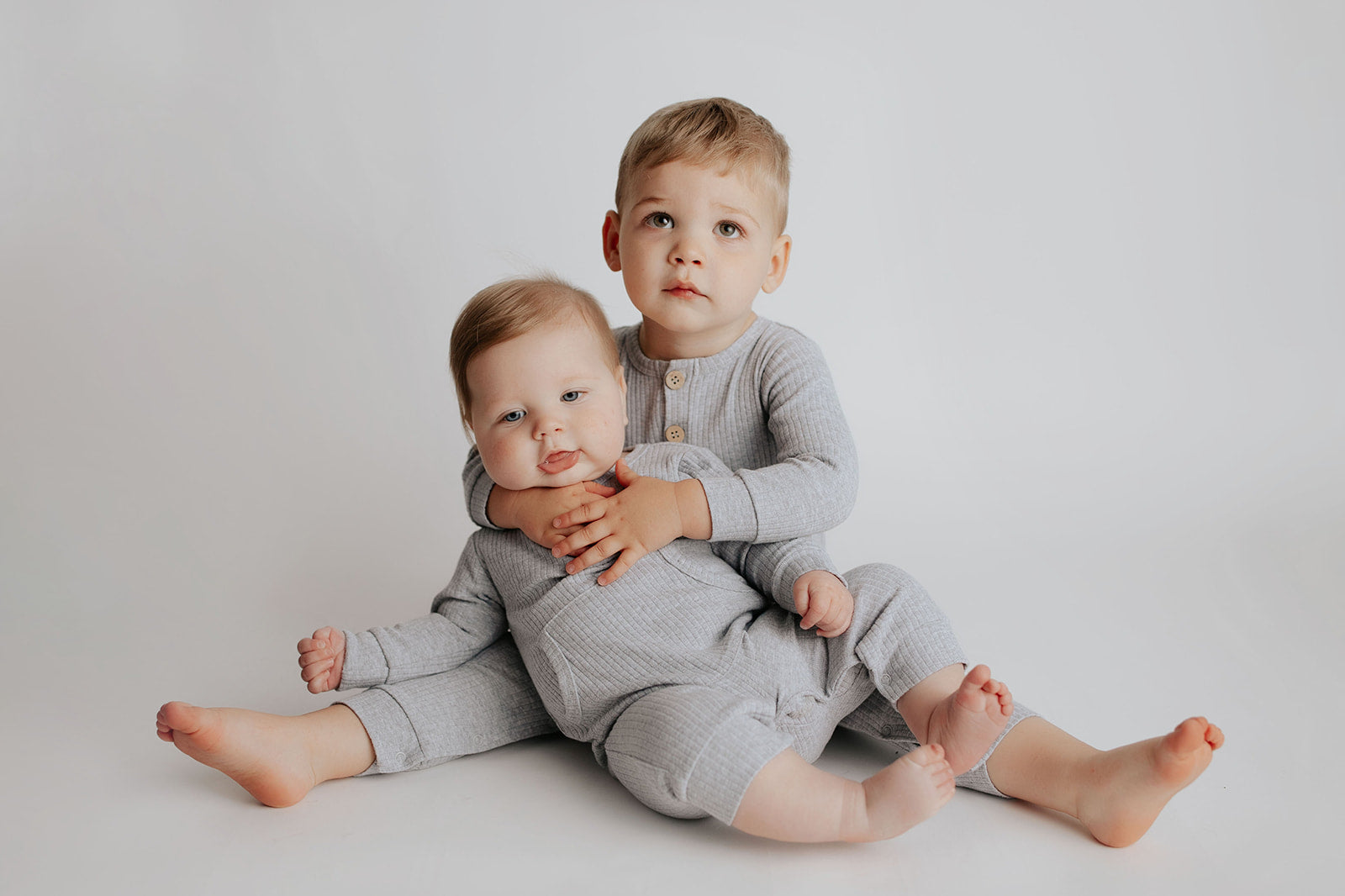 little brothers in matching Three Little Tots Playsuit made with Organic Cotton