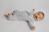 Stylish and functional, our ribbed organic cotton long-sleeve onesie features leg snaps and buttons for easy changes.