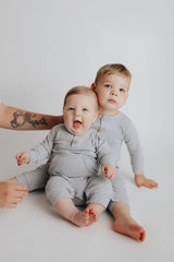little brothers in matching Three Little Tots Playsuit made with Organic Cotton