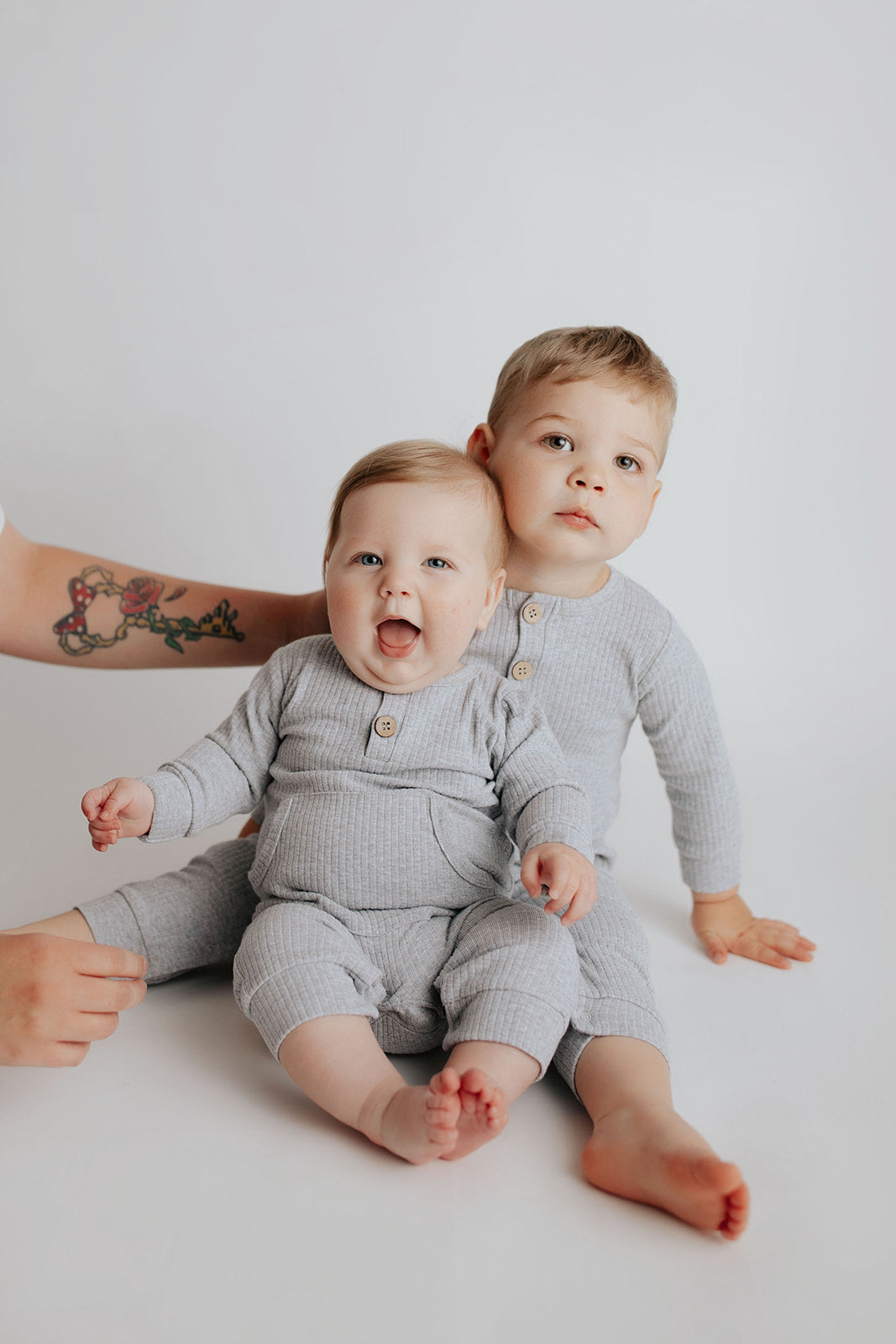 little brothers in matching Three Little Tots Playsuit made with Organic Cotton
