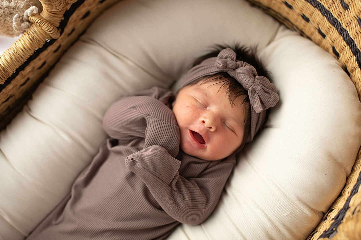 Ultra-soft, stretchy gender neutral baby gowns designed for comfort, featuring tie bottom and pull-down shoulder tabs for convenience. Cocoa Knotted Gown in a Snuggle Me Organics in a Plum + Sparrow Moses Baby Basket