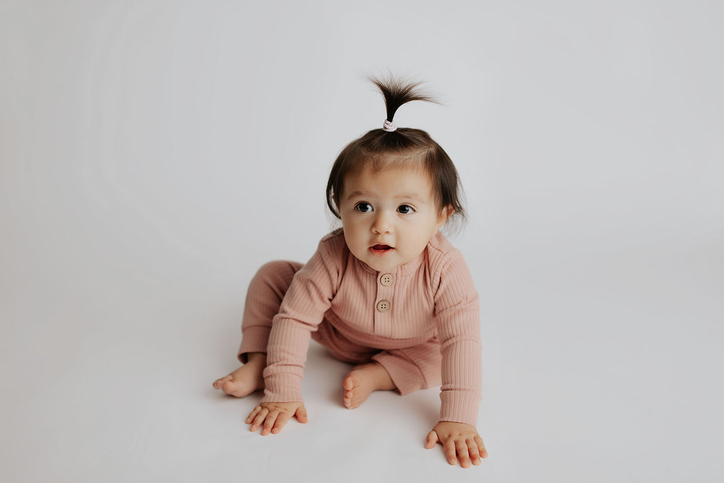 Luxuriously soft ribbed long-sleeve onesie with leg snaps, perfect for lounging and exploring in organic cotton.