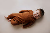 Ribbed long-sleeve onesie with two buttons and leg snaps, crafted from the softest organic cotton blend.