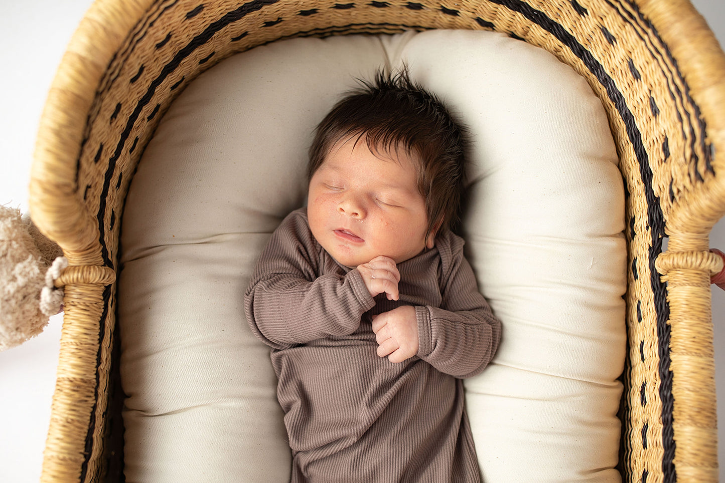 Ultra-soft, stretchy gender neutral baby gowns designed for comfort, featuring tie bottom and pull-down shoulder tabs for convenience. Cocoa Knotted Gown in a Snuggle Me Organics in a Plum + Sparrow Moses Baby Basket