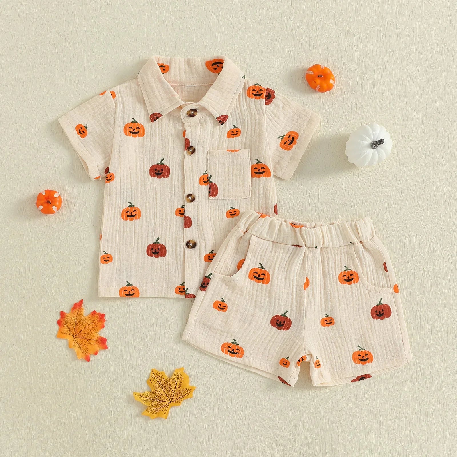 Children's outfit with pumpkin pattern shirt and shorts on a beige background