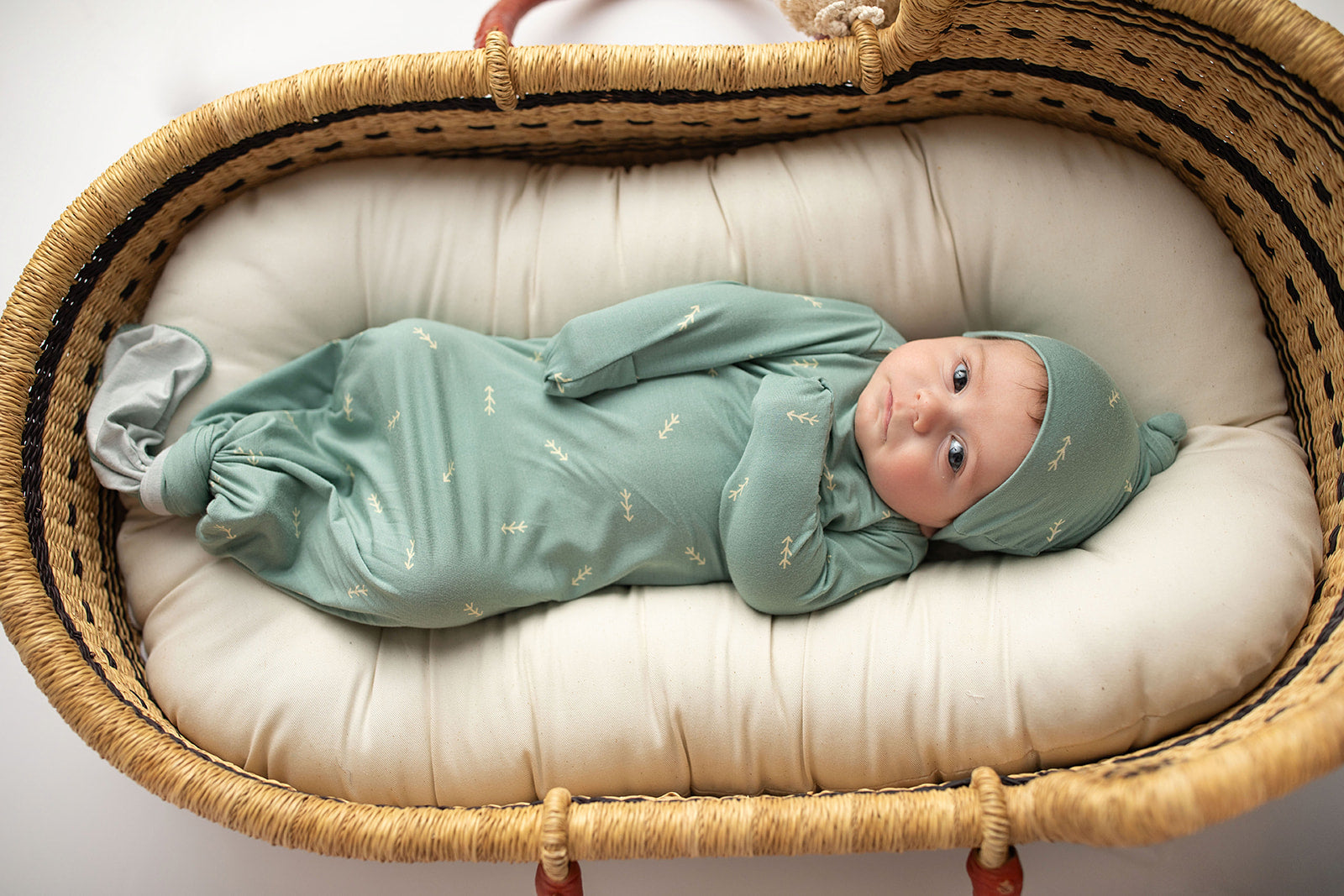 Three Little Tots Arrow Newborn Knotted Baby Gown. Ultra Soft baby gown. Newborn photoshoot idea with the Snuggle Me organic in a Plum + Sparrow Moses Baby Basket