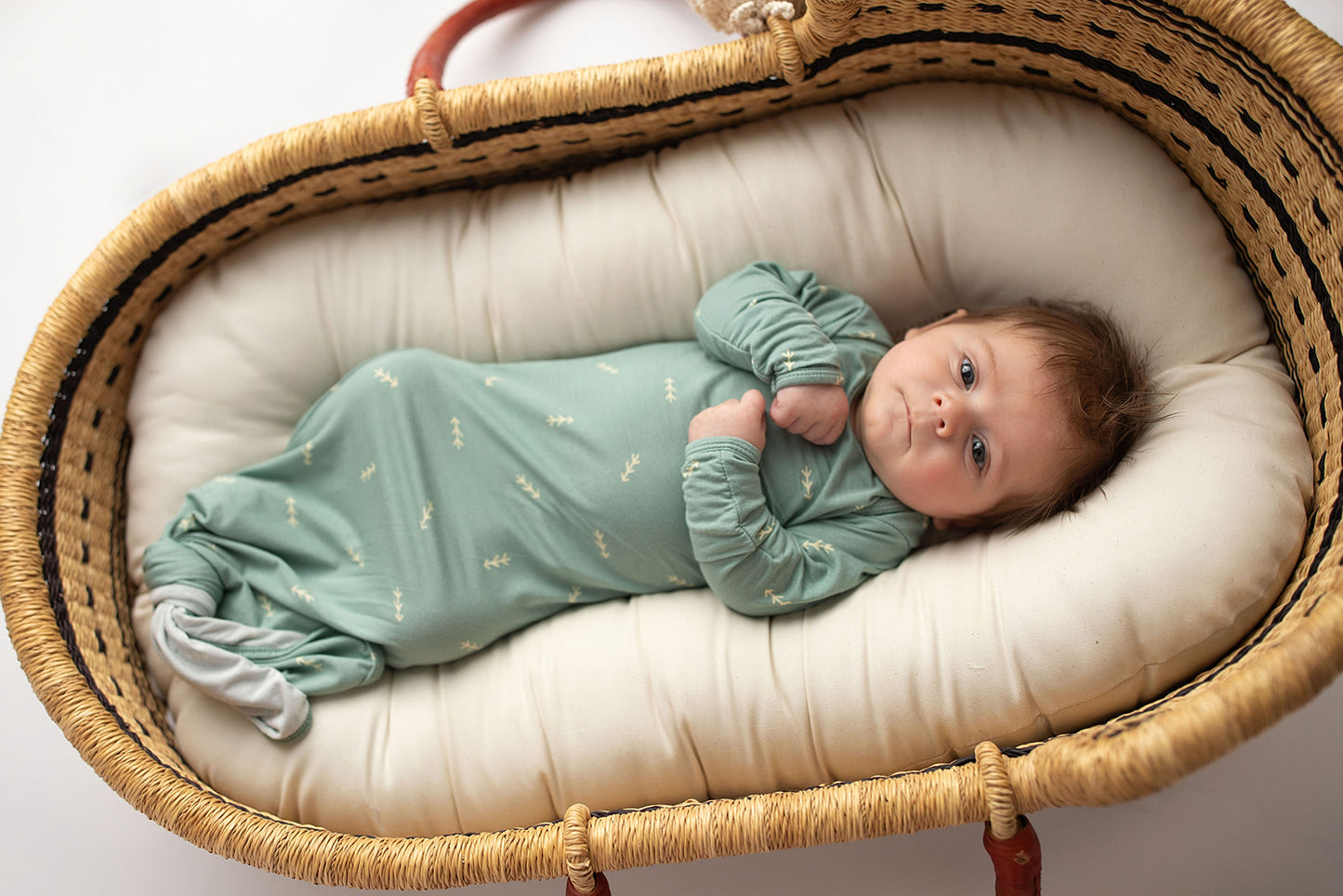 Three Little Tots Arrow Newborn Knotted Baby Gown. Ultra Soft baby gown. Newborn photoshoot idea with the Snuggle Me organic in a Plum + Sparrow Moses Baby Basket