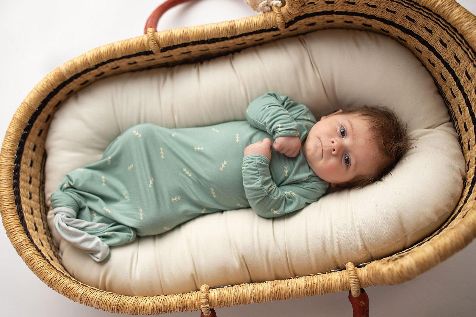 Three Little Tots Arrow Newborn Knotted Baby Gown. Ultra Soft baby gown. Newborn photoshoot idea with the Snuggle Me organic in a Plum + Sparrow Moses Baby Basket