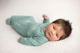 Three Little Tots Arrow Newborn Knotted Baby Gown. Newborn baby with a lot of hair. Newborn photoshoot.