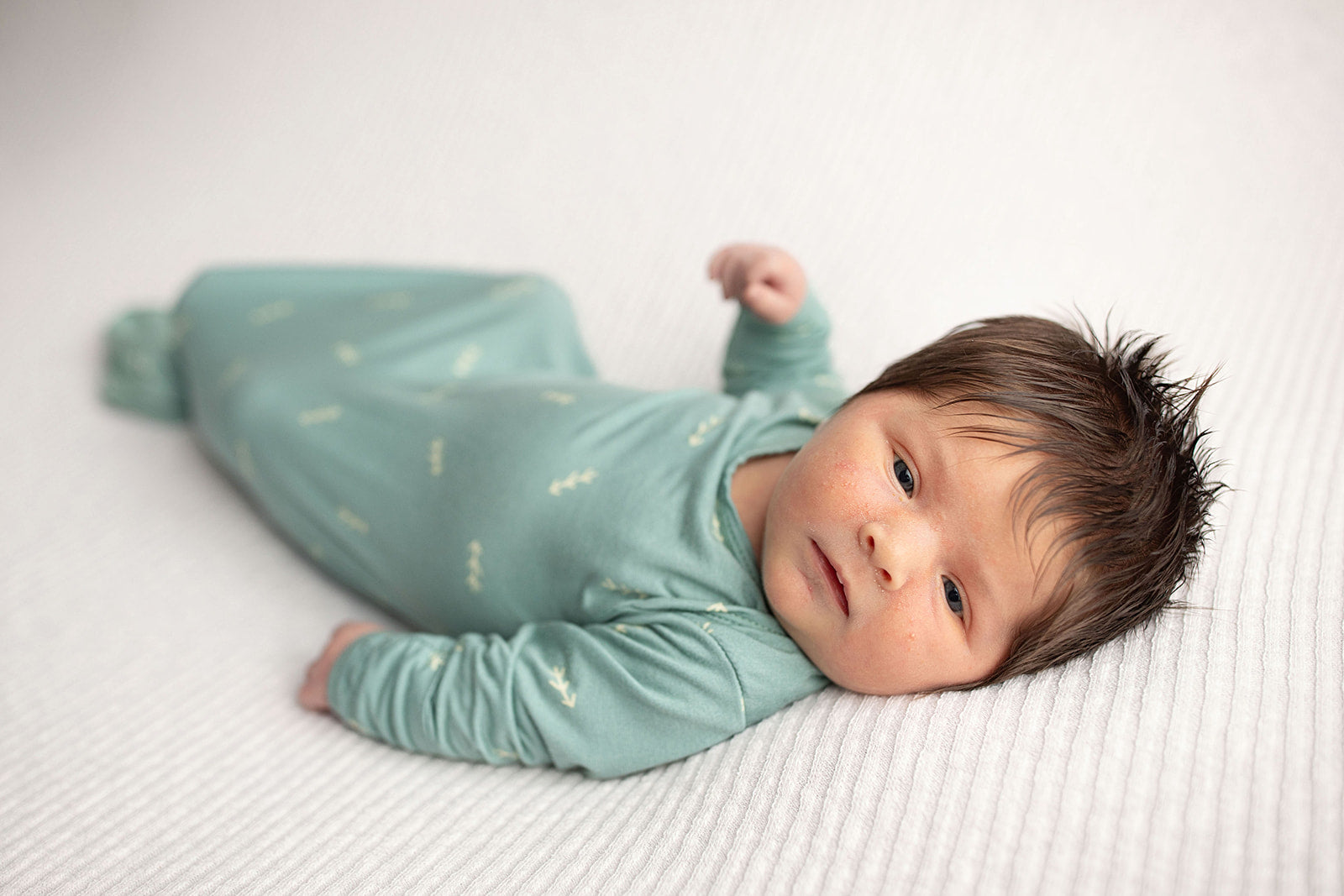 Three Little Tots Arrow Newborn Knotted Baby Gown. Newborn baby with a lot of hair. Newborn photoshoot.