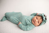 Three Little Tots Arrow Newborn Knotted Baby Gown with bow. Newborn baby girl with a lot of hair.
