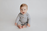Baby boy in a Three Little Tots playsuit outfit made with organic cotton