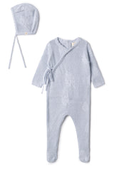 Baby outfit set with knitted romper and bonnet on a white background