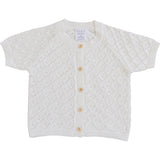 White baby cardigan with button details on a white background