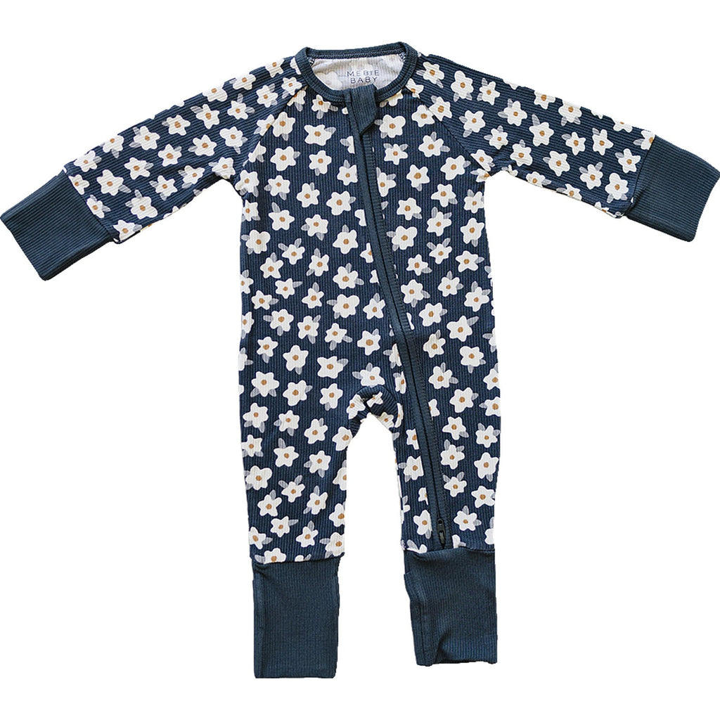 Navy baby onesie with white floral pattern on a white background