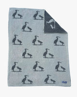 Gray blanket with black bird silhouettes on a white background
