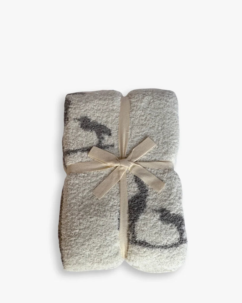 Folded blanket with a bow on a white background